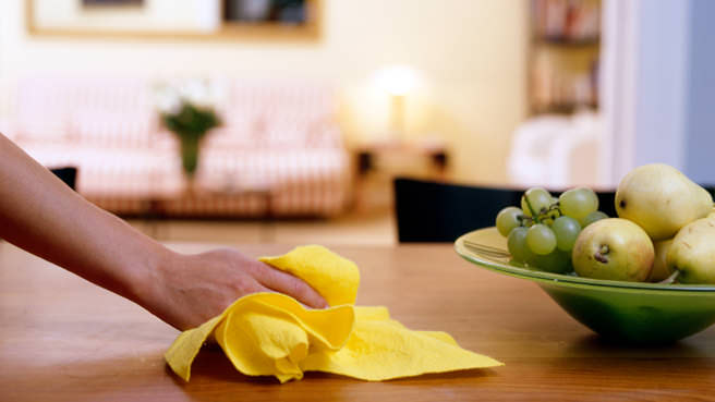 woman cleaning table