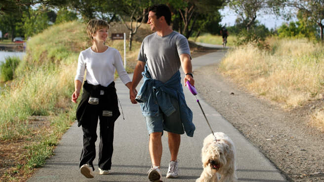 couple walking dog