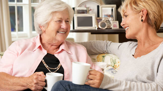 senior drinking tea with woman