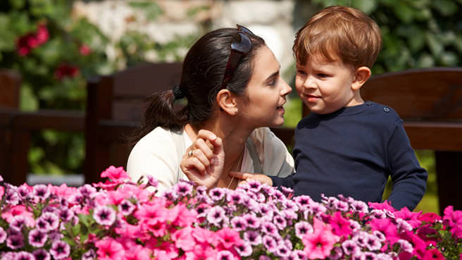 nanny looking at flowers with boy