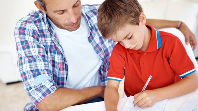 man helping little boy with homework